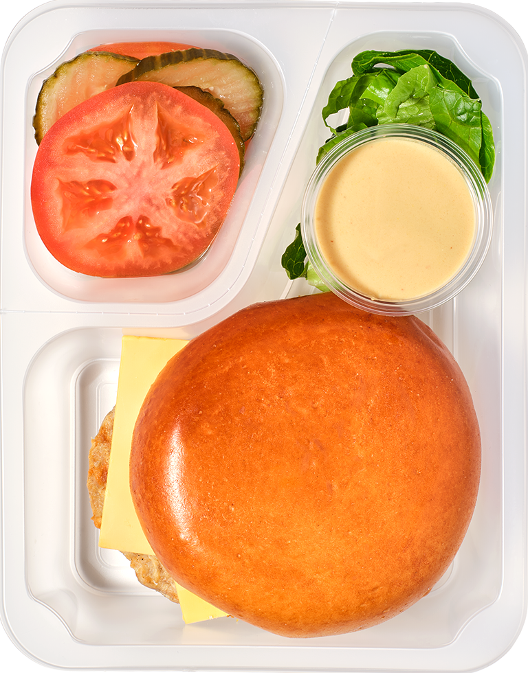 Chickenburger z warzywami, cheddarem i sosem złocistym